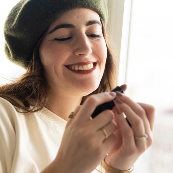 Smiling woman wearing lipstick color black baccara