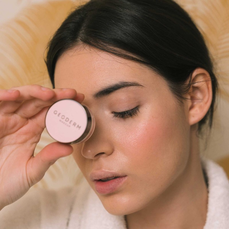 Woman face wearing powder blush color intense rose